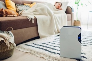 women sleeping while dehumudifier is placed on the floor