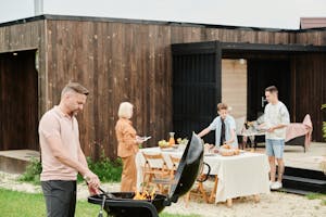 Family Enjoying Barbecue Party in Home Backyard